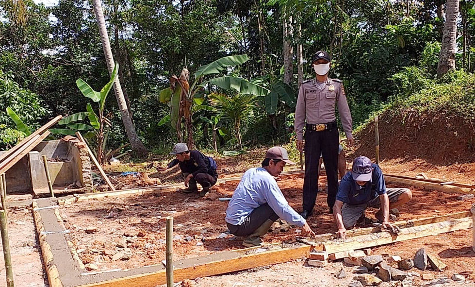 Bhabinkamtibmas Desa Tanjungjaya Monitoring Program Pembangunan Rutilahu di Dusun Cibuluh