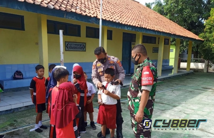 KBM Tatap Muka Telah Berjalan, Wujud Peduli Bahaya Covid, Polisi Bersama Anggota Koramil Bagikan Masker Kepada Pelajar SD 